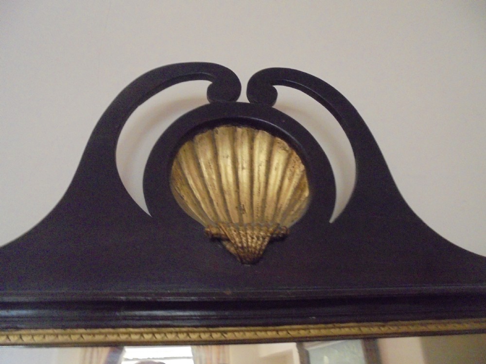 A Chippendale style dark mahogany wall mirror featuring carved fretwork cutout edges, a scrolled crest with a gilt shell motif, and a gilt slip framing the mirror glass. View II