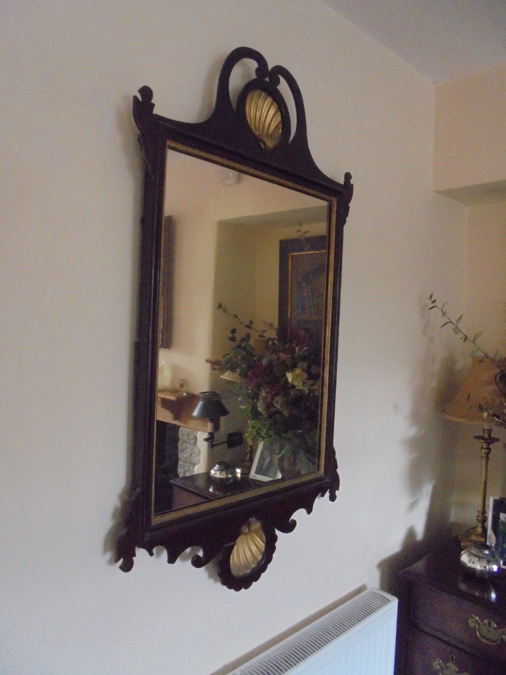 A Chippendale style dark mahogany wall mirror featuring carved fretwork cutout edges, a scrolled crest with a gilt shell motif, and a gilt slip framing the mirror glass. View III