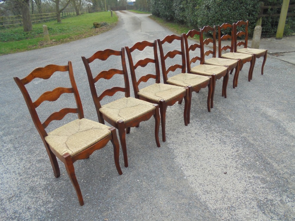Set of eight French walnut ladder back chairs View III