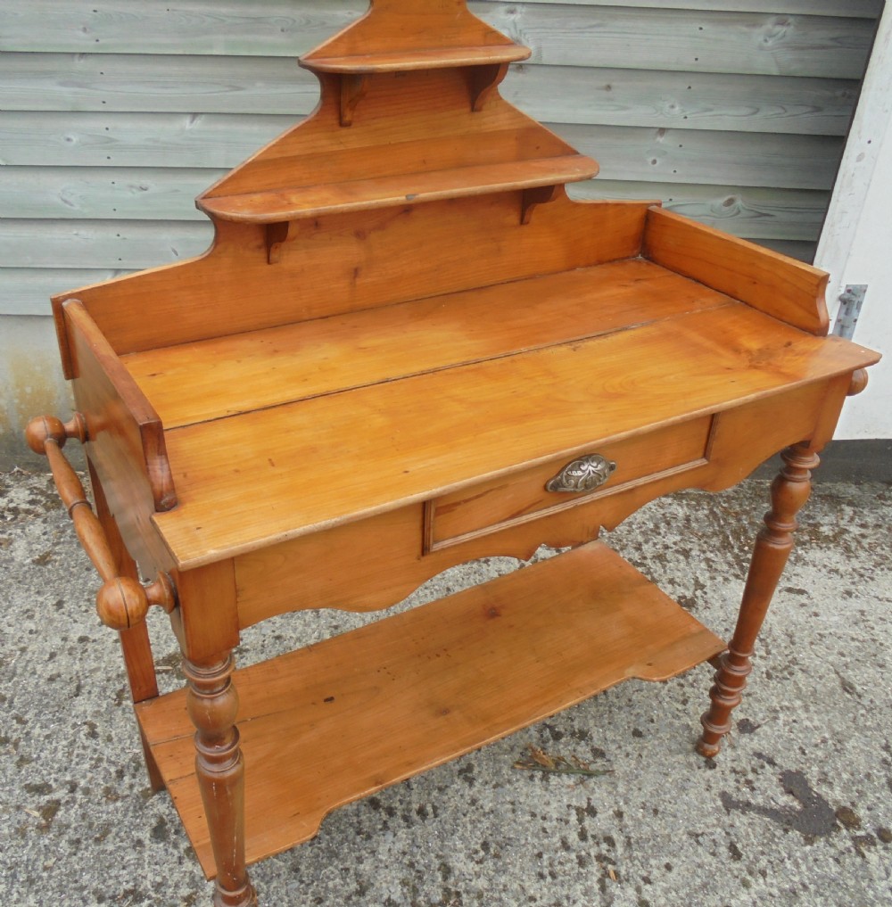 A 19th-century French cherry wood dressing table with two tiered upper shelves, turned legs, a single drawer, and an open lower shelf. View IV
