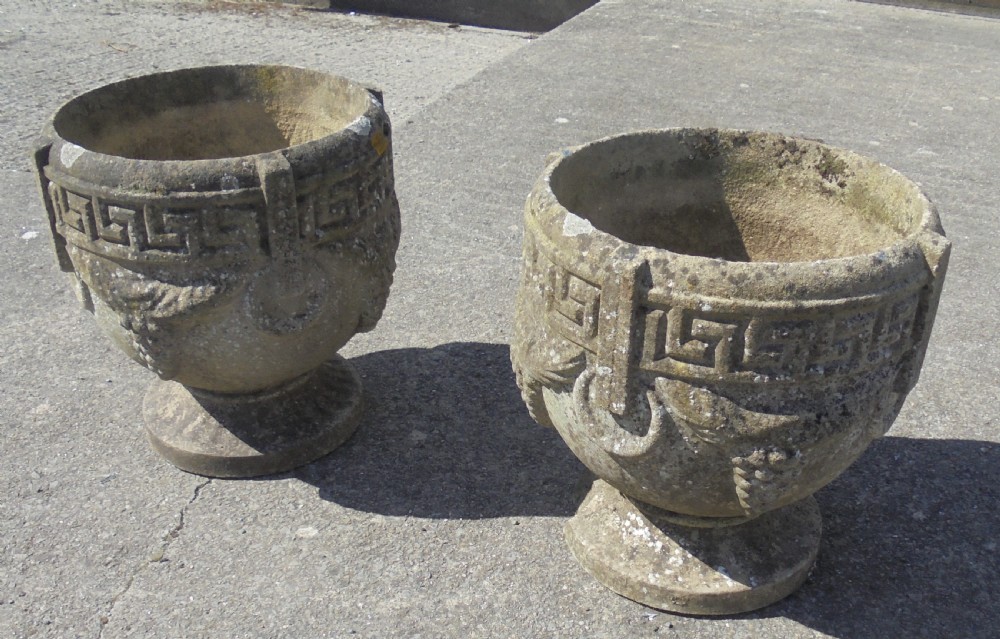 Pair of weathered sandstone garden urns planters