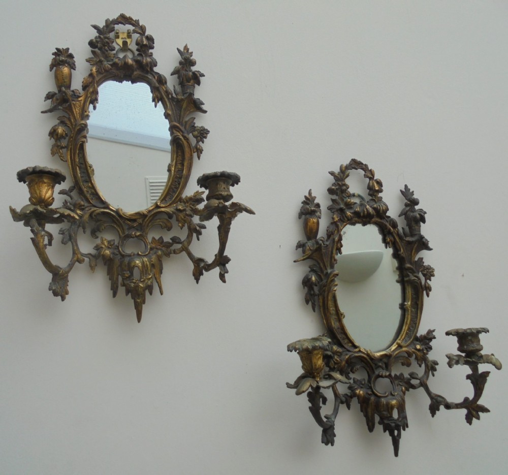 Ornate pair of French gilded wall mirrors with candle sconces