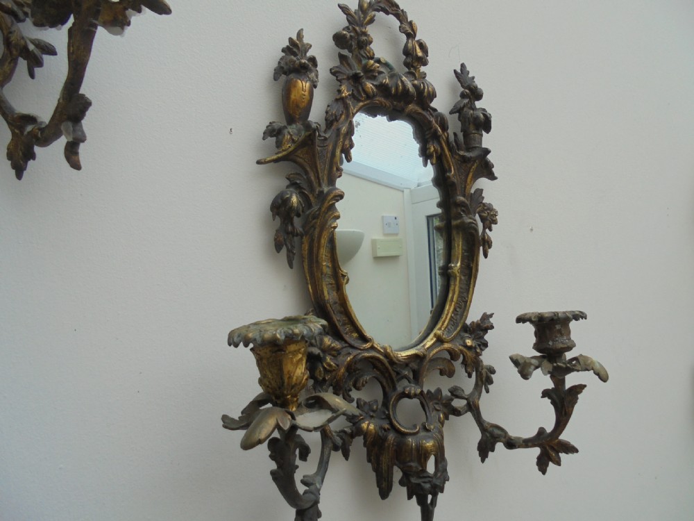 Ornate pair of French gilded wall mirrors with candle sconces View II