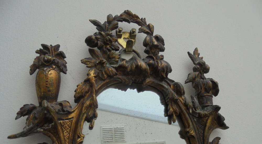 Ornate pair of French gilded wall mirrors with candle sconces View V