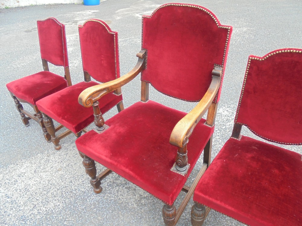 A set of seven late Victorian oak dining chairs upholstered in deep crimson velvet with brass studding, comprising six side chairs and one carver armchair. View IV