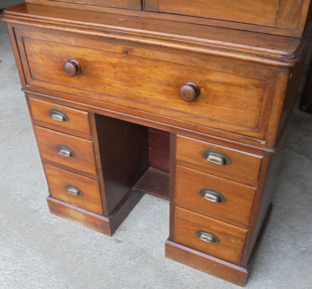 A Victorian mahogany post masters desk featuring a two-door upper cabinet above a central wide drawer and twin pedestal drawers with metal cup handles. View II