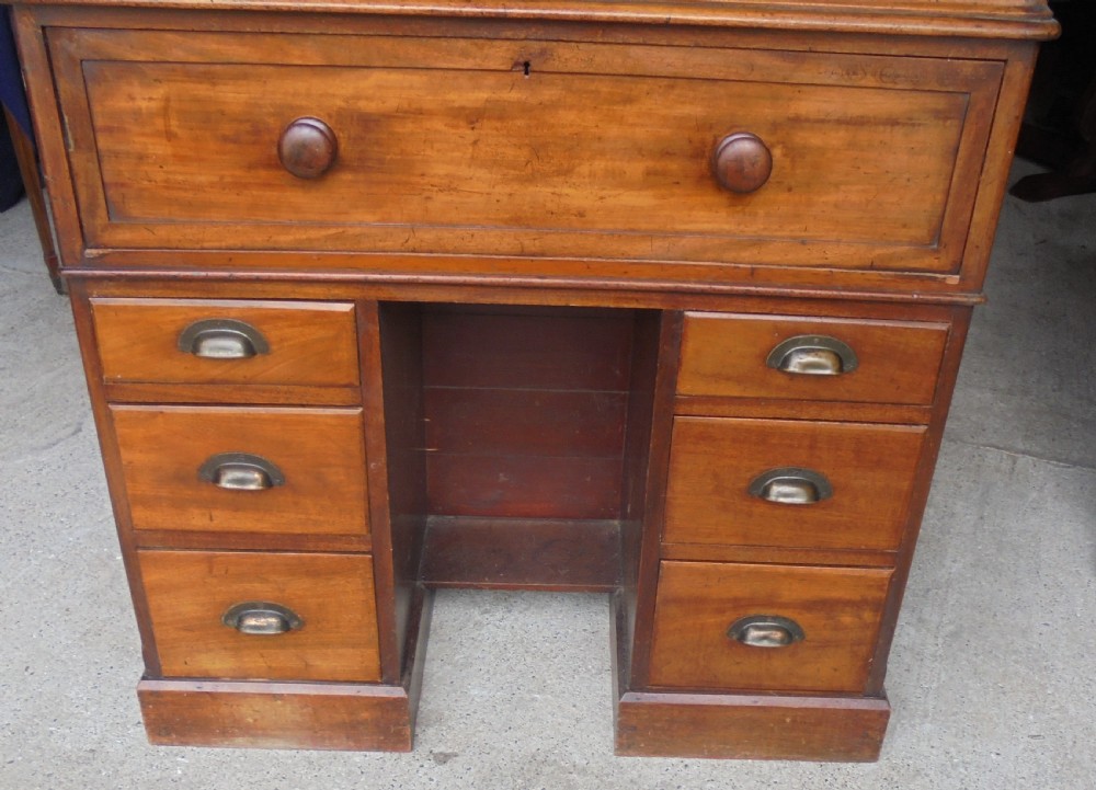 A Victorian mahogany post masters desk featuring a two-door upper cabinet above a central wide drawer and twin pedestal drawers with metal cup handles. View IV