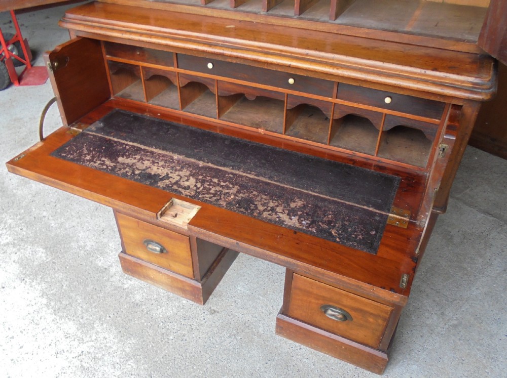 A Victorian mahogany post masters desk featuring a two-door upper cabinet above a central wide drawer and twin pedestal drawers with metal cup handles. View VII