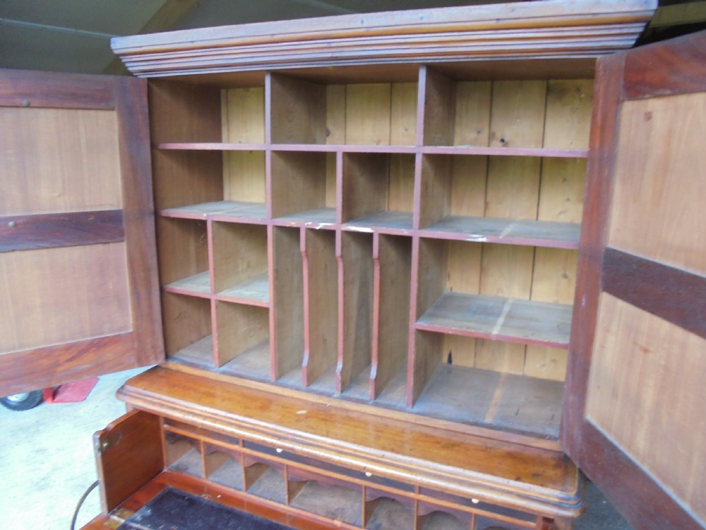 A Victorian mahogany post masters desk featuring a two-door upper cabinet above a central wide drawer and twin pedestal drawers with metal cup handles. View VIII