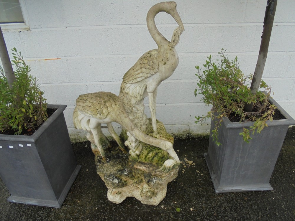 Weathered Carved marble statue of two cranes feeding 