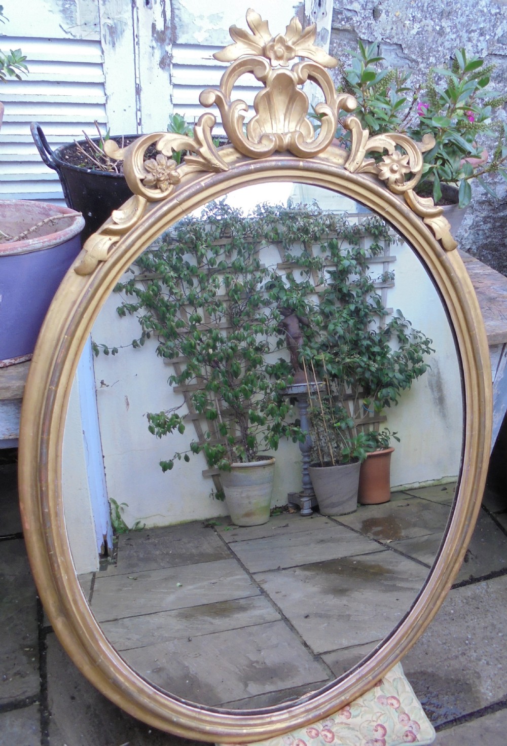 Large 18th century oval gilded wood wall mirror