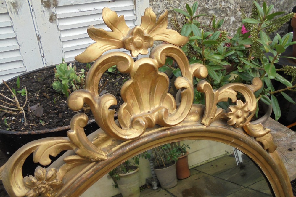 Large 18th century oval gilded wood wall mirror View IV