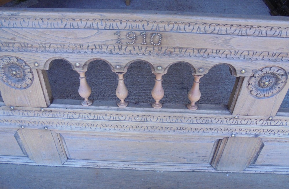 A natural light timber French country bench featuring a carved backrest with small turned spindles and panelled sections. View III