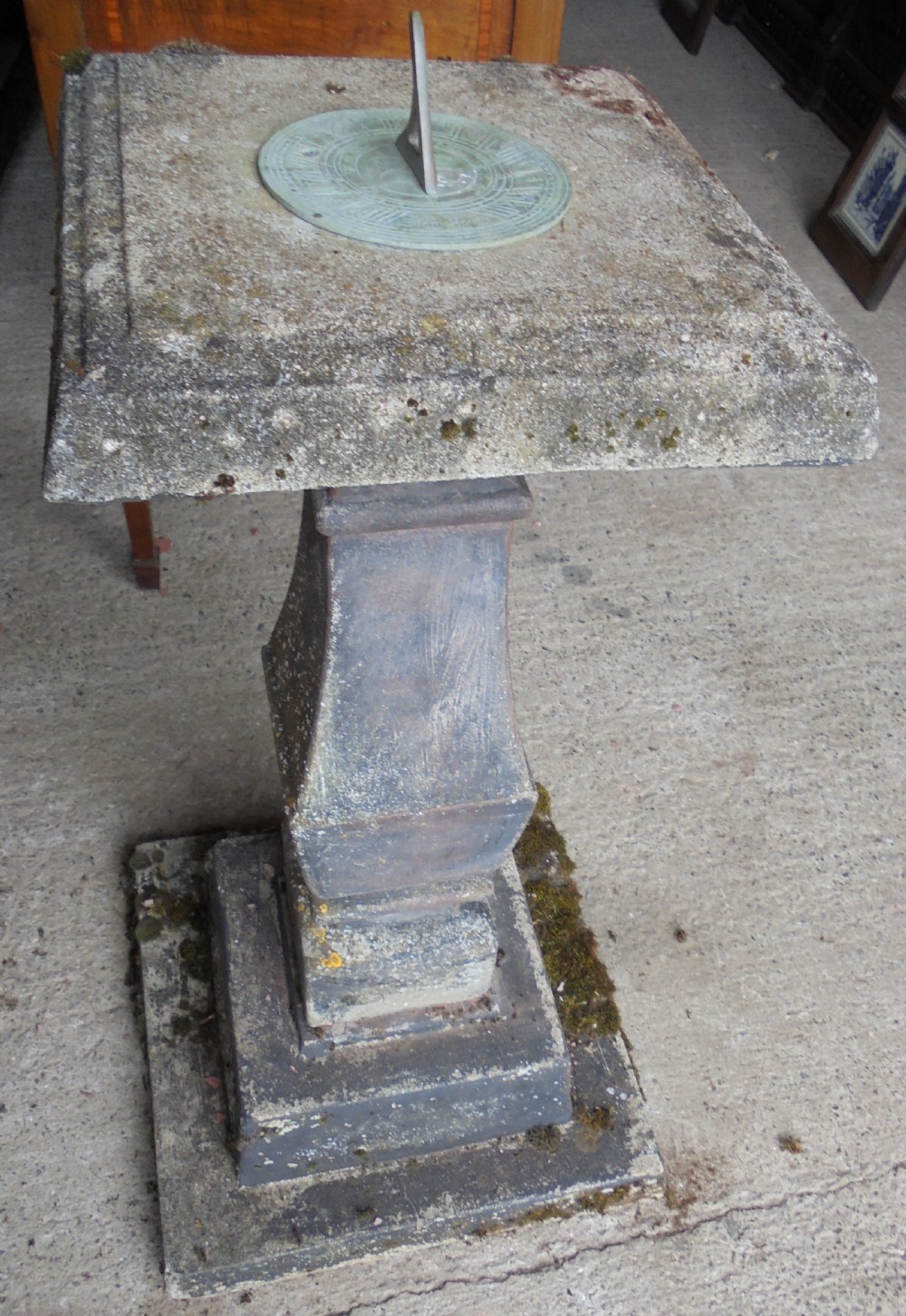 Sun dial on well weathered stand 
