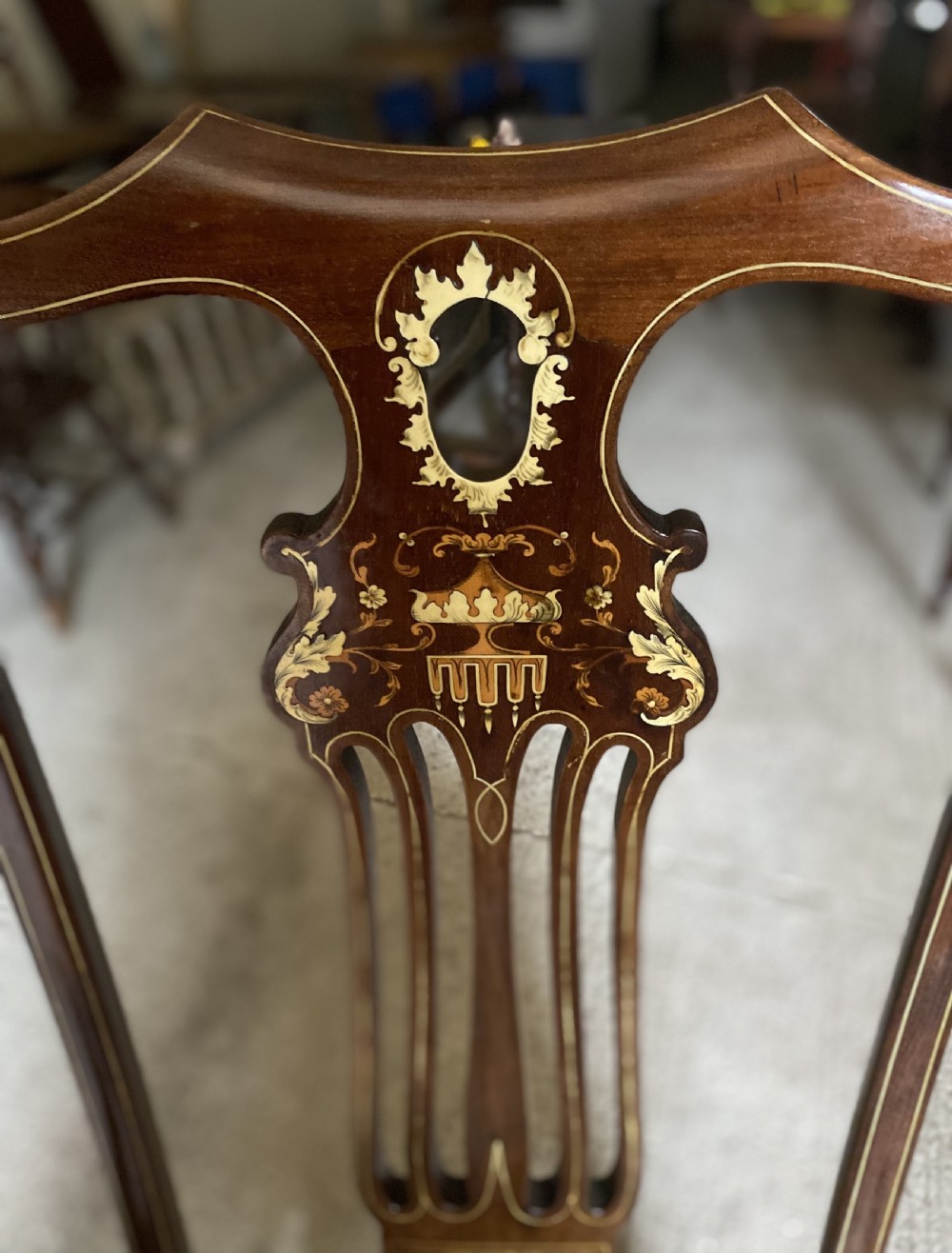 A high-back mahogany armchair featuring detailed marquetry inlay on the splat and arms with an upholstered seat. View III