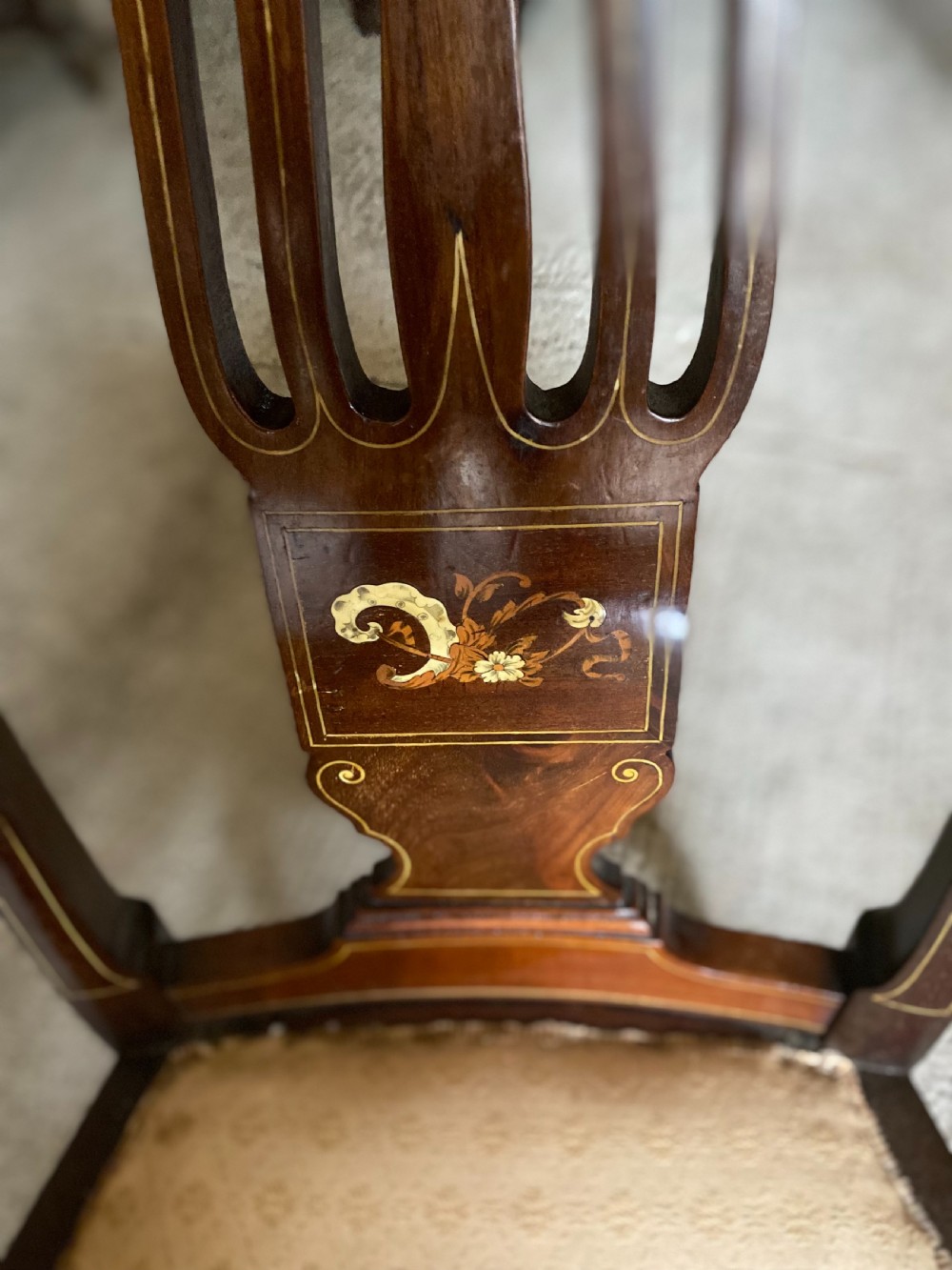 A high-back mahogany armchair featuring detailed marquetry inlay on the splat and arms with an upholstered seat. View IV