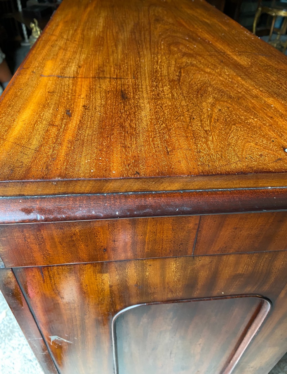 A nineteenth-century mahogany linen press cupboard featuring two panelled doors, recessed side panels, and a moulded top cornice. View II