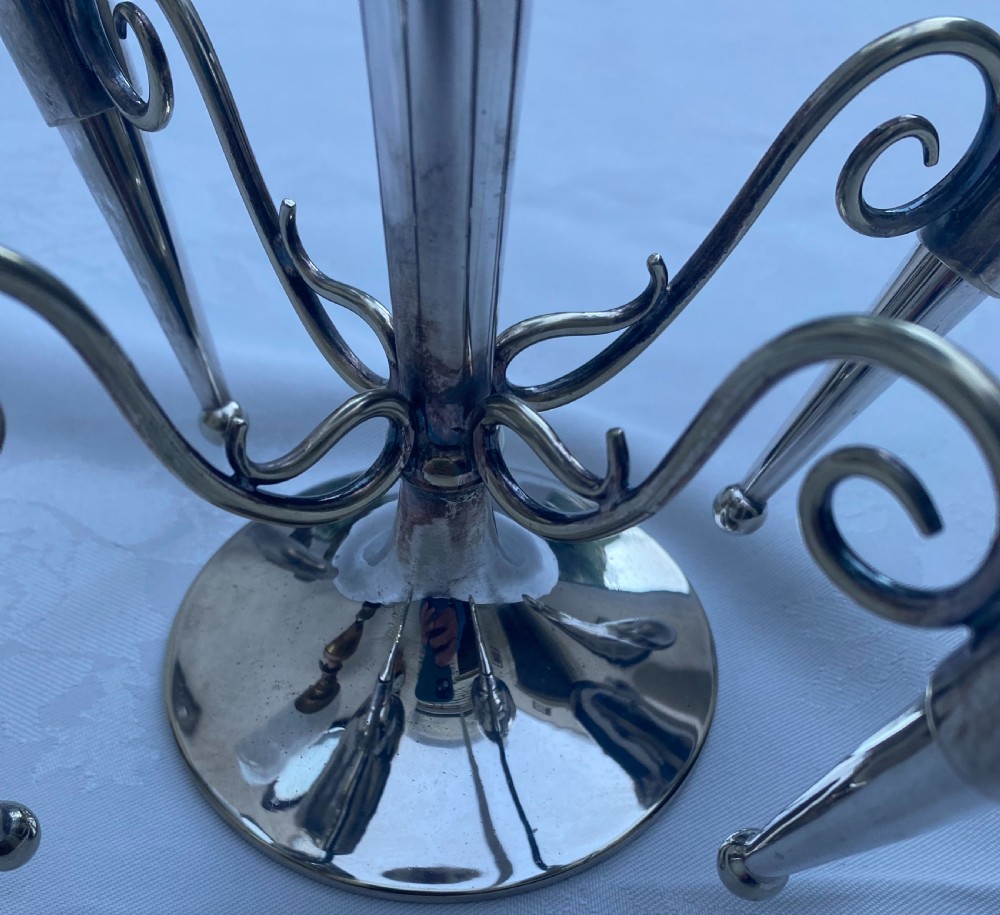 A silver-plated five-trumpet table epergne featuring a central tall trumpet vase surrounded by four smaller branching fluted vases on scroll arms. View III