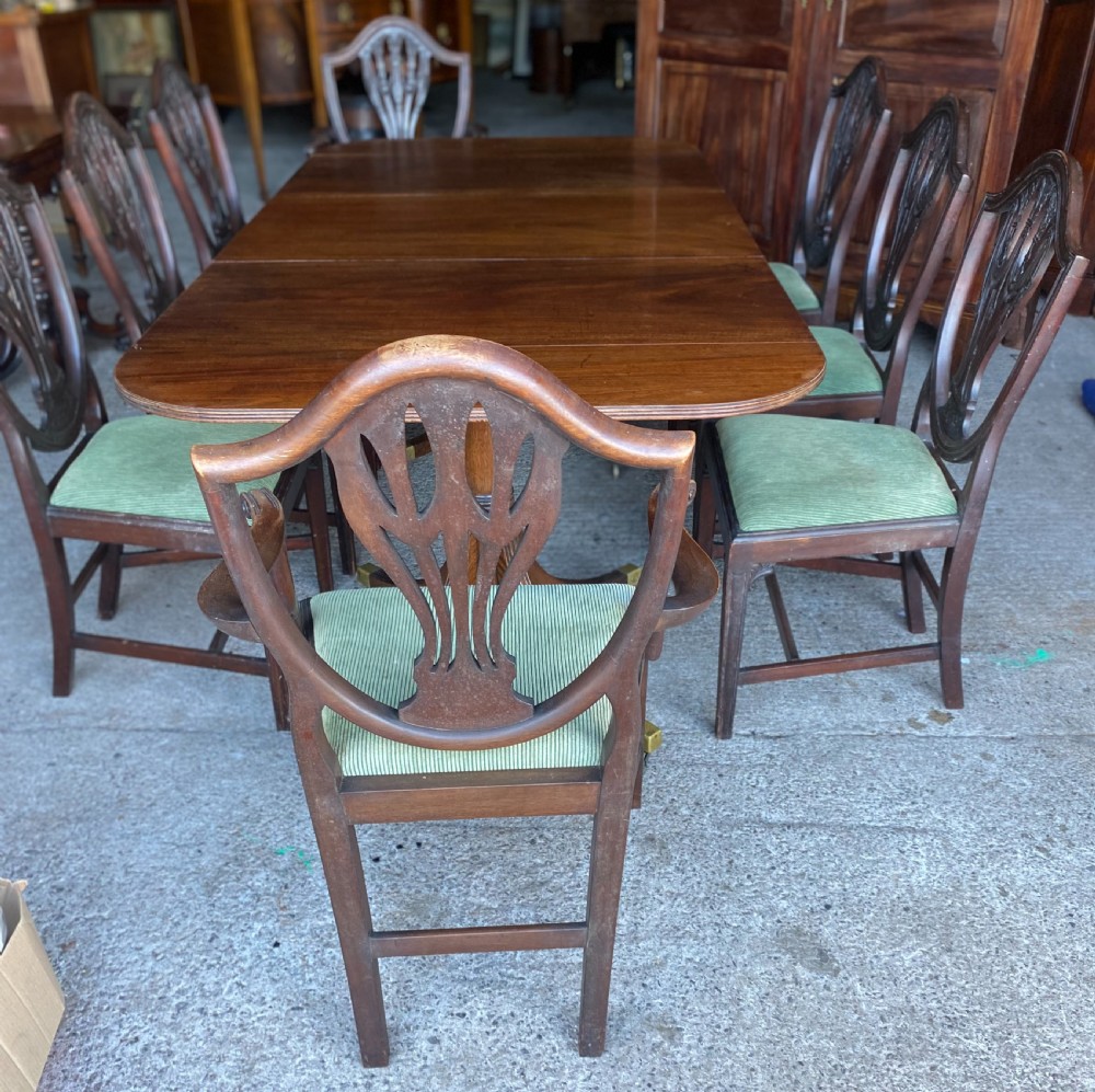 A 19th-century mahogany twin pillar dining table featuring reeded splayed legs, brass toe caps, and rounded tabletop corners. View II