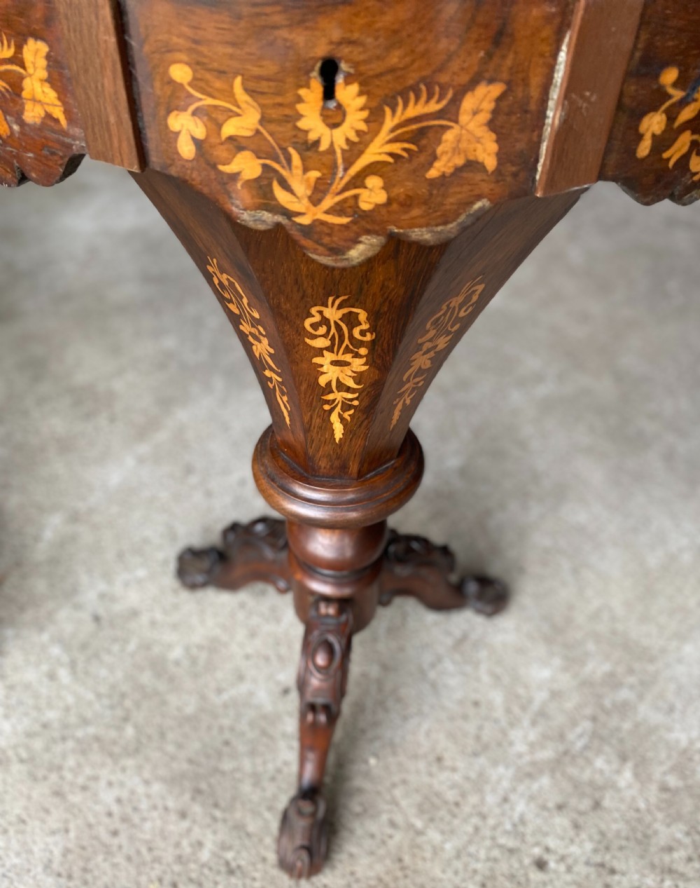 A Victorian dark rosewood trumpet work table featuring satinwood floral marquetry and an equestrian motif on top, raised on a tripod pedestal base. View V