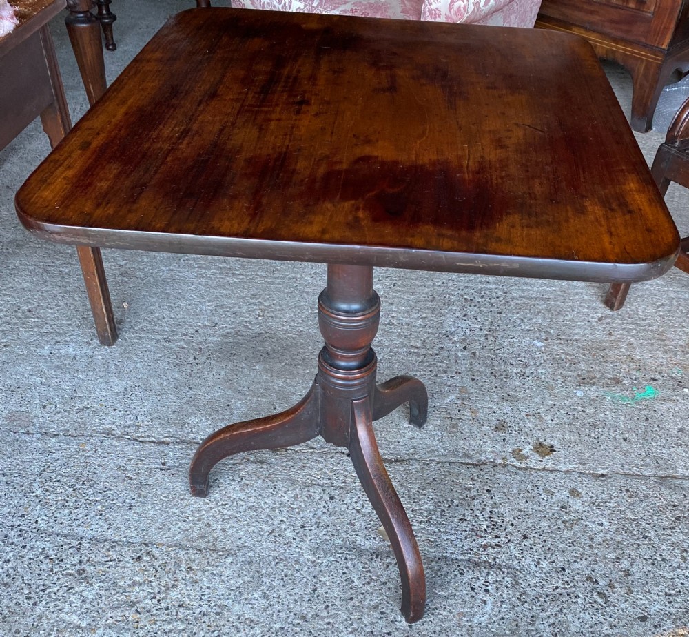 An 18th-century mahogany occasional table featuring a square top with rounded corners, supported by a central turned pedestal column and three splayed legs. View II
