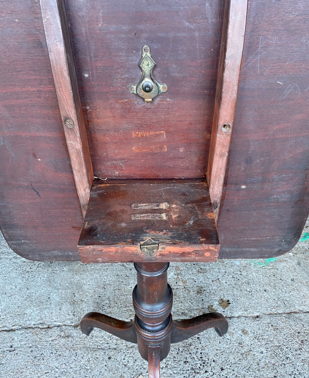 An 18th-century mahogany occasional table featuring a square top with rounded corners, supported by a central turned pedestal column and three splayed legs. View IV