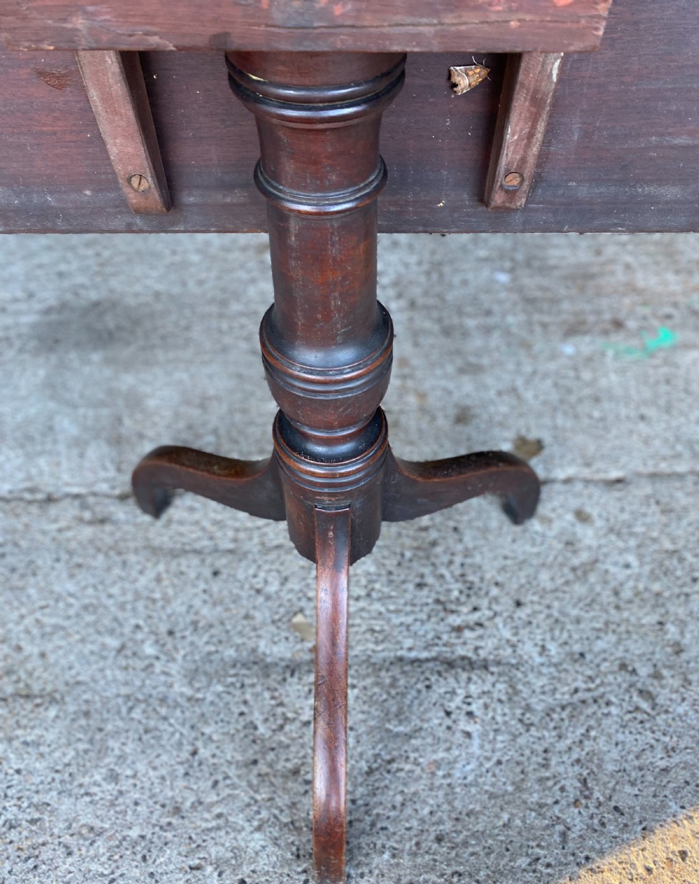An 18th-century mahogany occasional table featuring a square top with rounded corners, supported by a central turned pedestal column and three splayed legs. View V