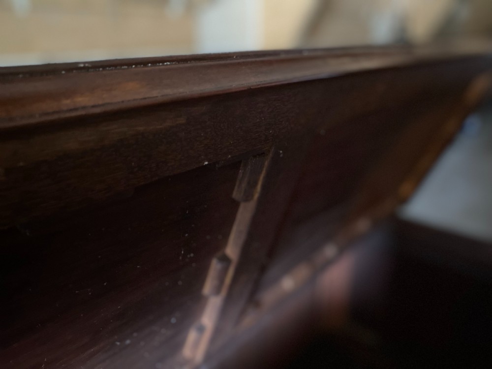 An eighteenth-century mahogany storage chest featuring a hinged top lid, multiple faux drawer fronts, brass swan-neck handles, key escutcheons, and fluted corner pilasters. View II
