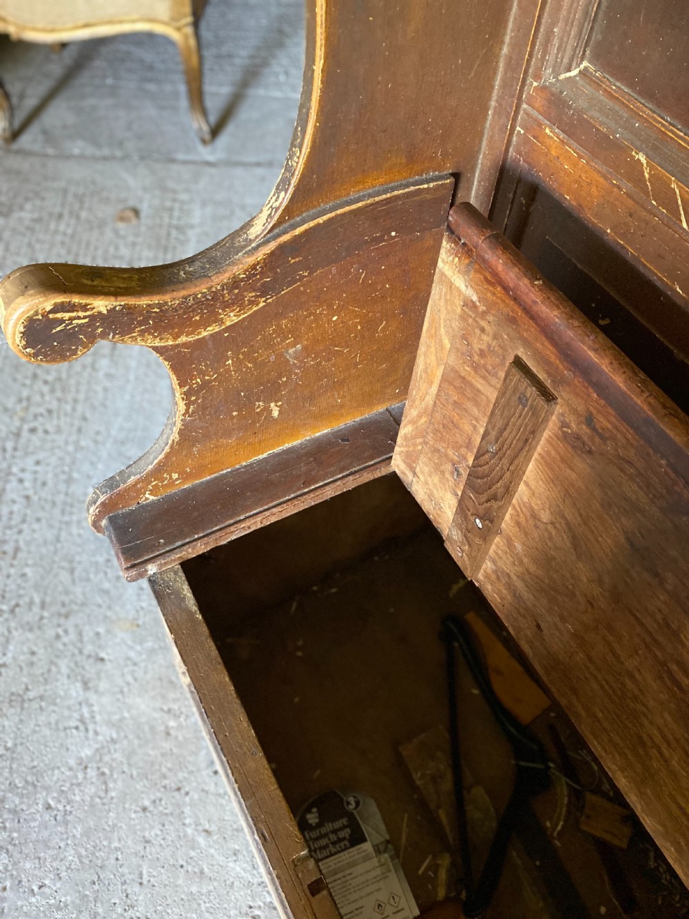A large 19th-century high-back wooden settle featuring a multi-panelled back, winged draught sides, dark distressed finish, and a hinged seat box base. View II