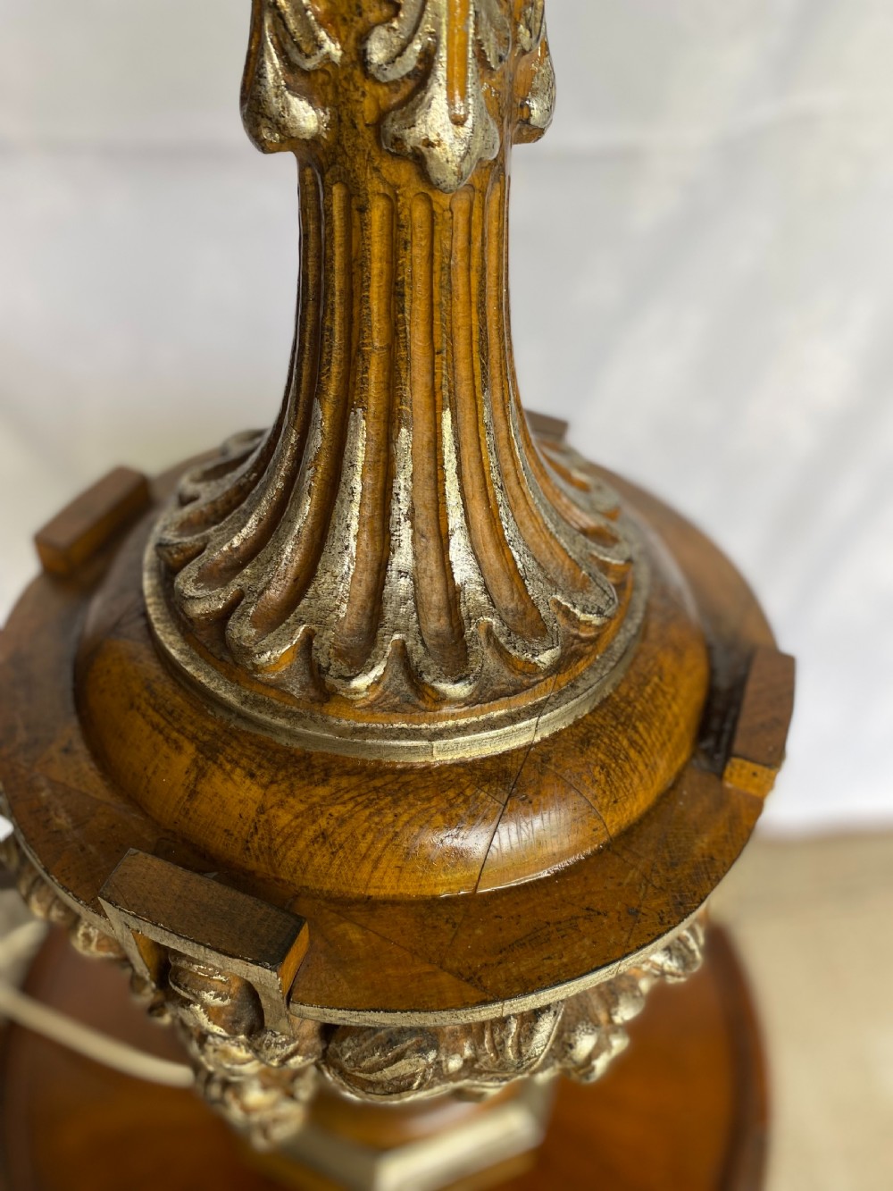A tall carved walnut table lamp featuring an architectural column design with an Ionic capital, fluted shaft, carved urn base, and gold leaf highlights. View V