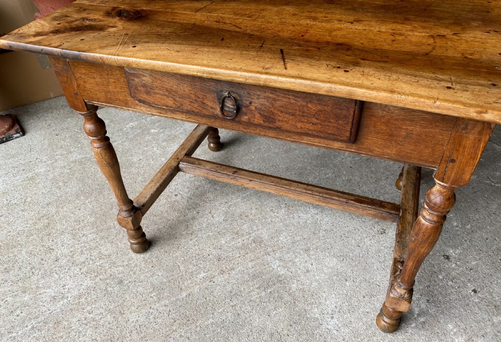An 18th-century French fruitwood occasional table featuring a rectangular top, single drawer with an iron ring handle, turned legs, and a low stretcher base. View III