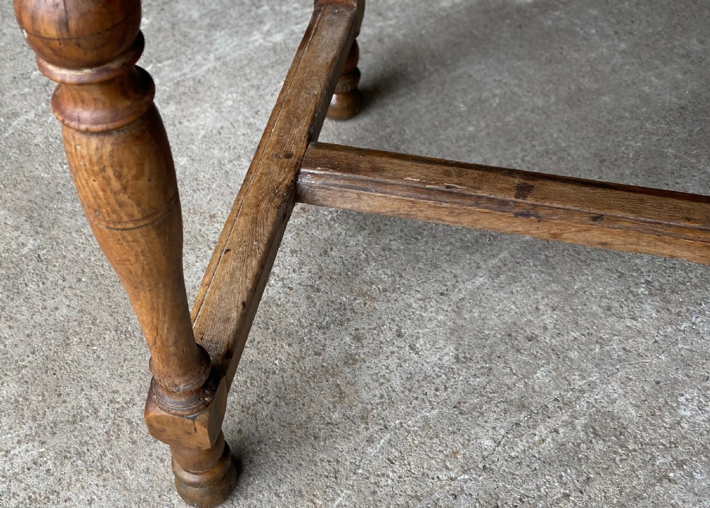 An 18th-century French fruitwood occasional table featuring a rectangular top, single drawer with an iron ring handle, turned legs, and a low stretcher base. View VIII