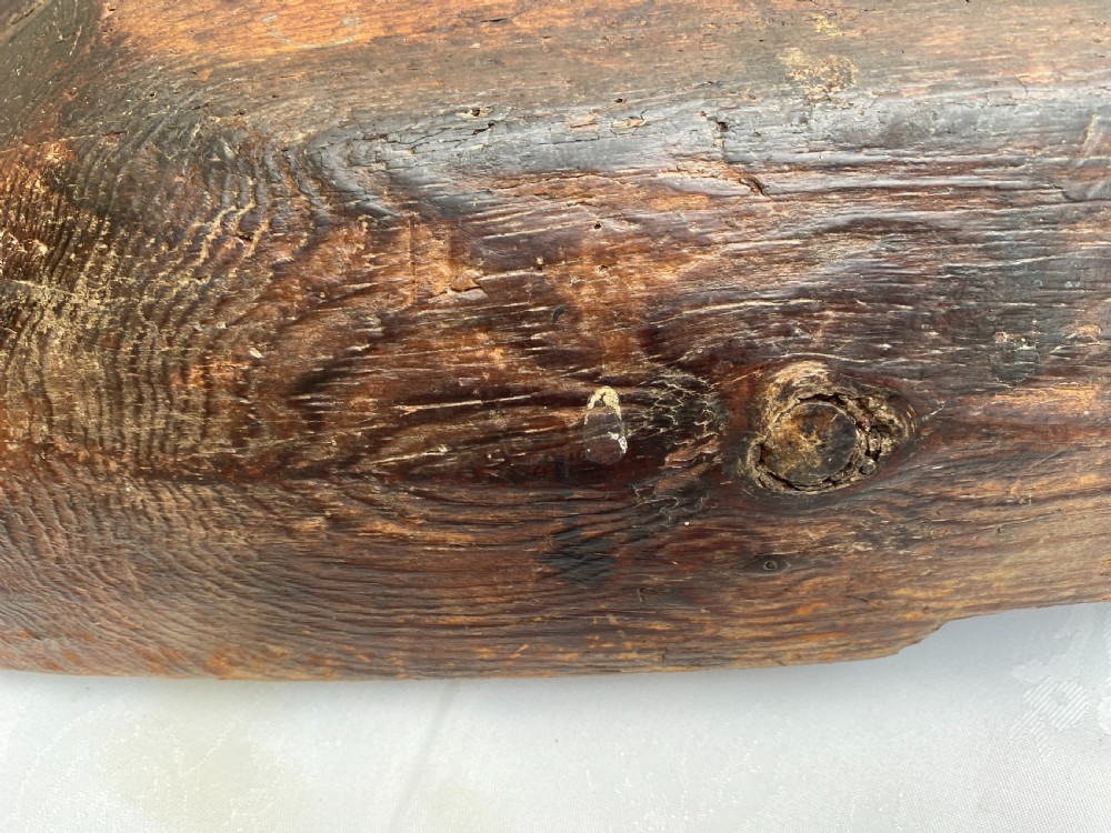 A long hand-carved dark wood bowl featuring incised star motifs on the raised rim handles and a hollowed interior. View VIII