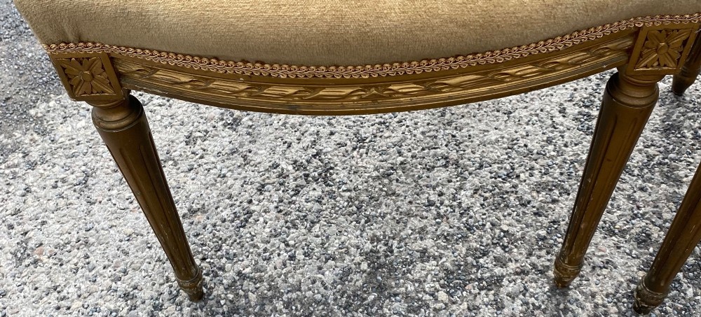 A set of four 19th-century French Louis XVI style side chairs featuring carved gilded wooden frames with oval medallion backs and beige velvet upholstery. View III