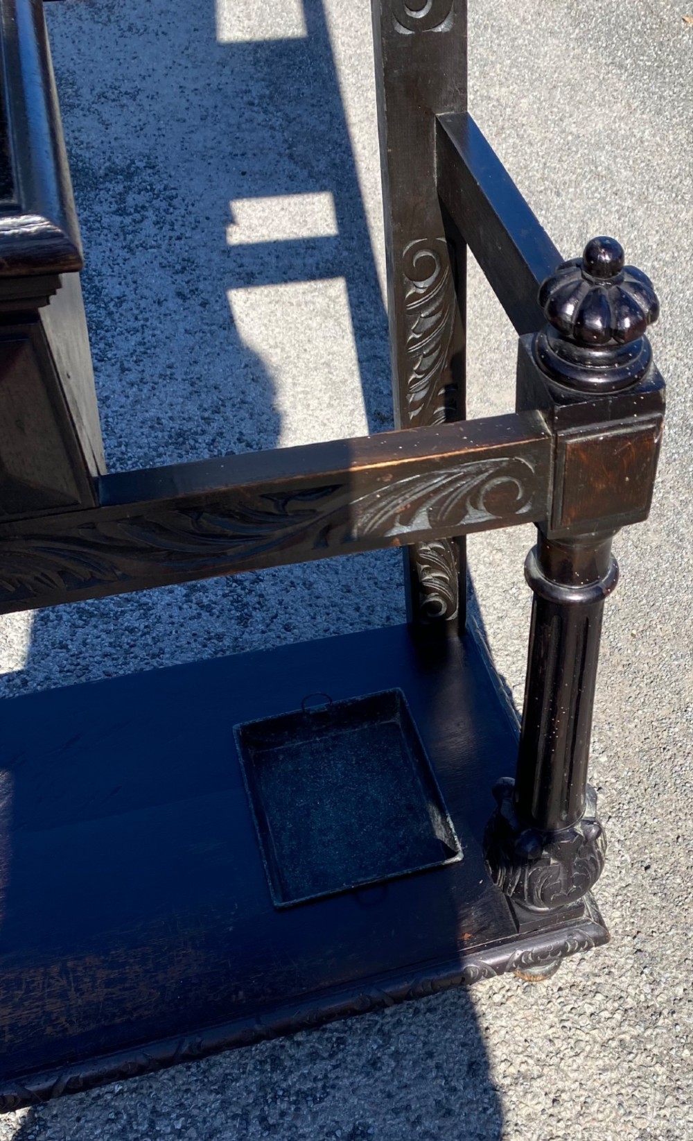 A dark carved oak Victorian hall stand featuring a central rectangular mirror, lion mask carvings, turned coat pegs, umbrella holders, and metal drip trays. View VIII