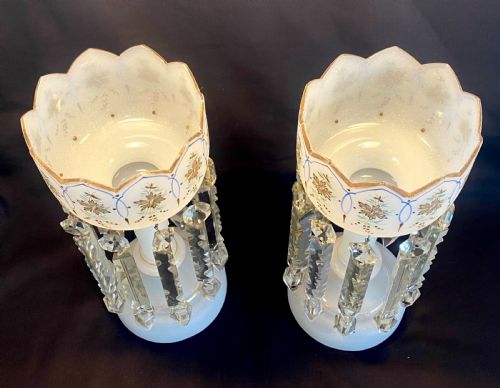 fig 1. A pair of frosted white French opaline glass table lustres featuring crenellated rims, gilded floral motifs, and suspended clear cut-crystal drop prisms.