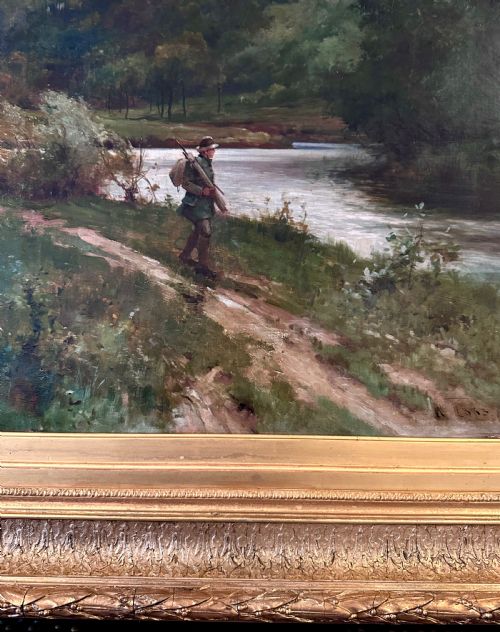 fig 2. An antique late Victorian oil painting depicting a figure walking along a riverbank path in a rural countryside landscape, framed in a moulded giltwood frame.
