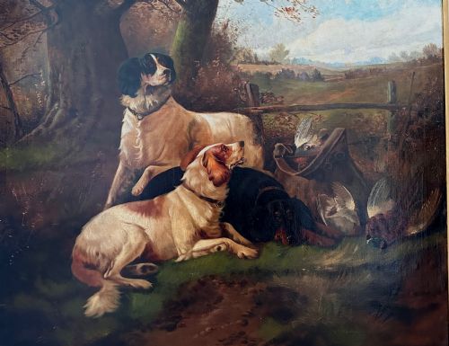 fig 2. An oil painting on canvas depicting gun dogs lying beside harvested game birds in a rural landscape, framed in an ornate gold leaf frame.