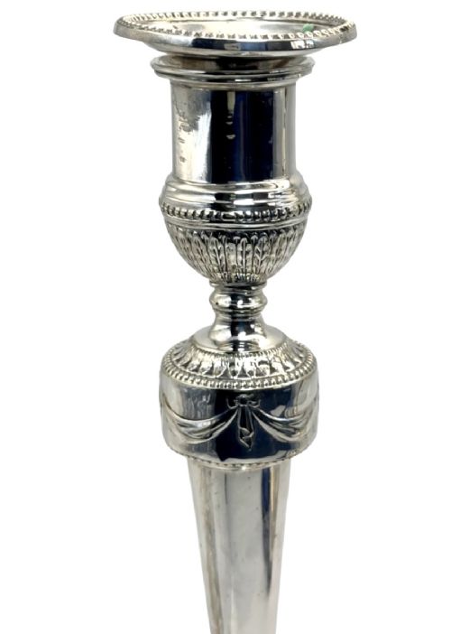 A pair of silver-plated candlesticks with tapered shafts, classical drapery swag motifs, and beaded circular bases. View IV