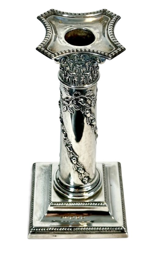 A pair of polished silver column candlesticks featuring Corinthian capitals, foliate swags, and stepped beaded bases. View V