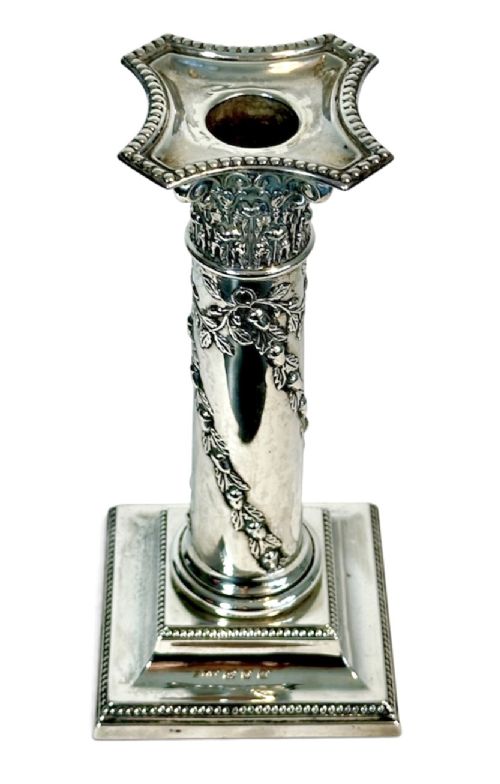 A pair of polished silver column candlesticks featuring Corinthian capitals, foliate swags, and stepped beaded bases. View IX