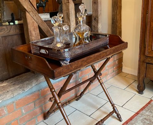 fig 1. A rectangular silver-plated gallery tray featuring pierced fretwork sides, integrated oval hand-holds, an engraved surface, and ornate scrolled feet.