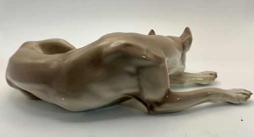 fig 2. A glazed Nymphenburg porcelain figurine depicting a recumbent Great Dane dog in taupe grey and neutral tones.