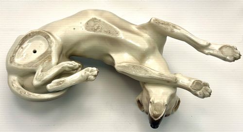 fig 4. A glazed Nymphenburg porcelain figurine depicting a recumbent Great Dane dog in taupe grey and neutral tones.