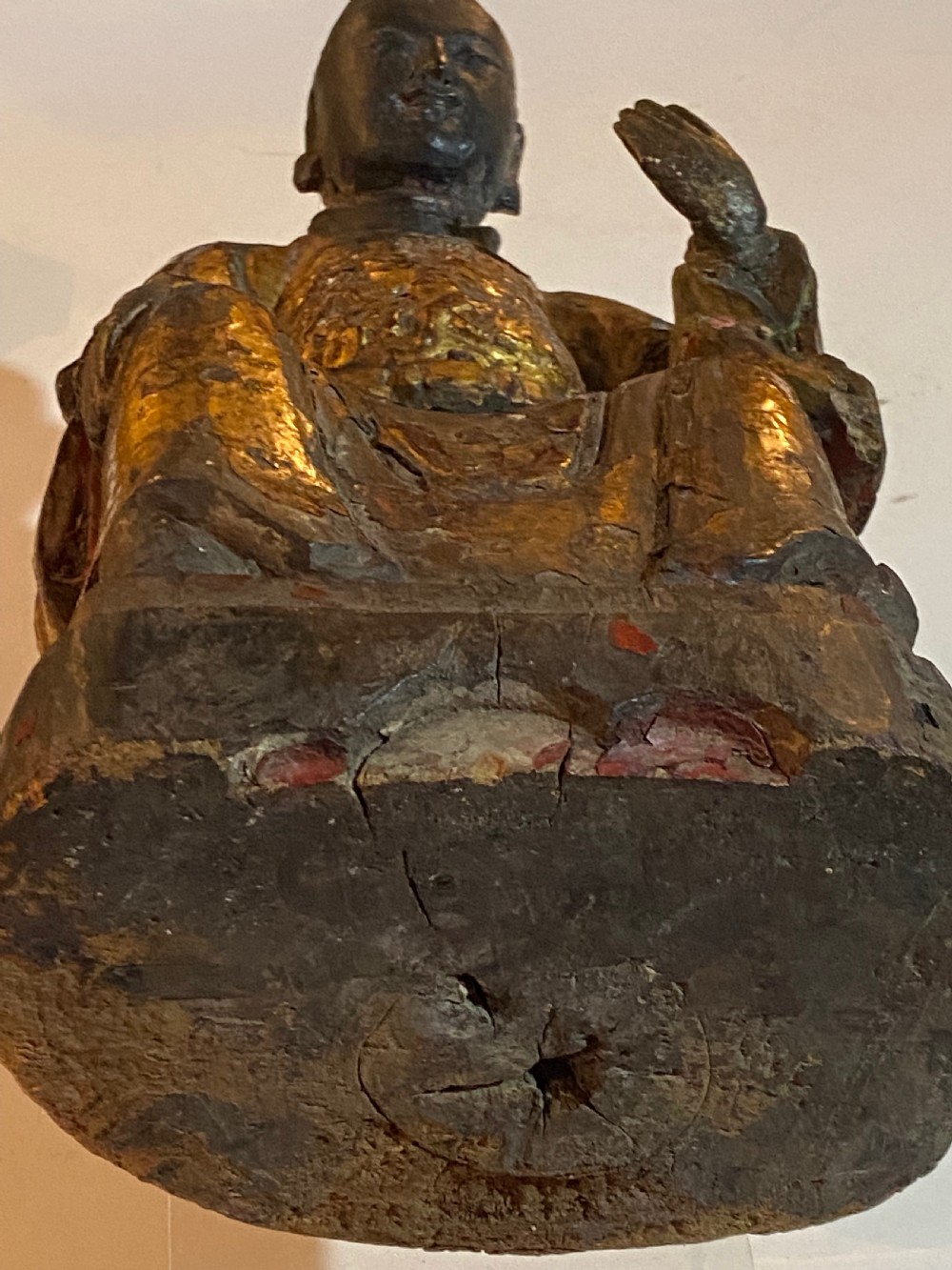 An eighteenth-century hand-carved wooden Chinese deity statue featuring worn gold leaf gilding and dark lacquer finish in a seated pose. View X