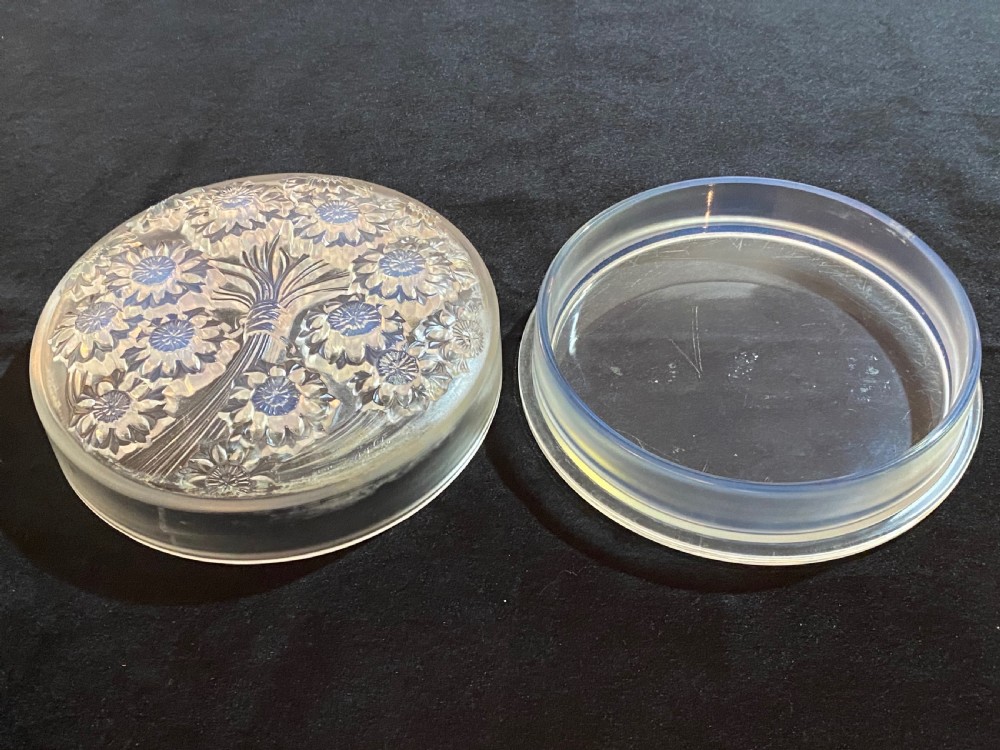 A circular French Art Deco opalescent glass box and cover with a raised moulded floral motif. View II