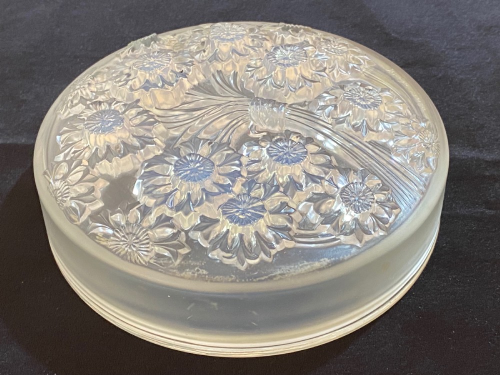 A circular French Art Deco opalescent glass box and cover with a raised moulded floral motif. View IV