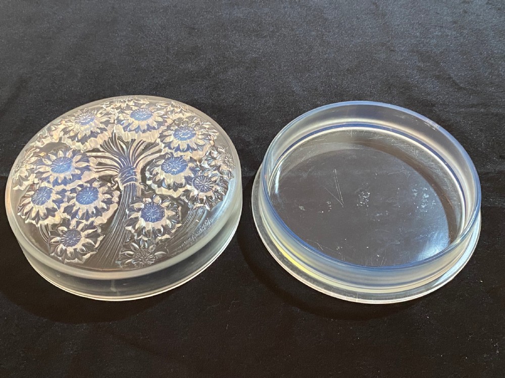 A circular French Art Deco opalescent glass box and cover with a raised moulded floral motif. View V