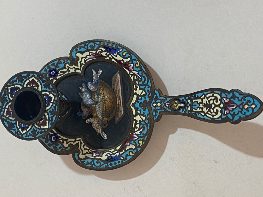 An antique metal chamberstick decorated with turquoise cloisonne enamel scrollwork surrounding a central micromosaic panel of birds drinking from a bowl. View V