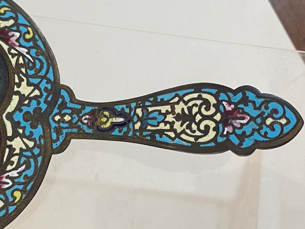 An antique metal chamberstick decorated with turquoise cloisonne enamel scrollwork surrounding a central micromosaic panel of birds drinking from a bowl. View VIII